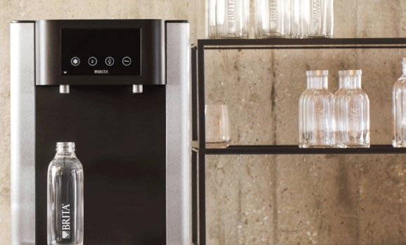 BRITA Fill Pro high-volume dispenser on a hotel reception counter dispensing sparkling water - UK