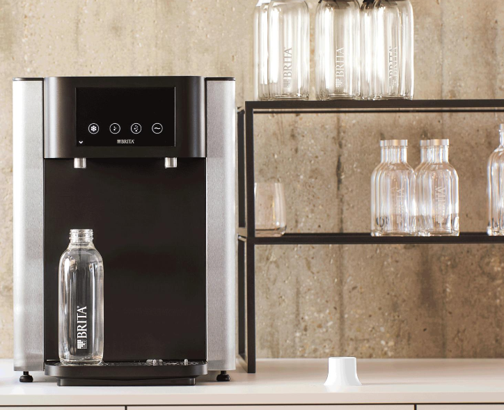 BRITA Fill Pro high-volume dispenser on a hotel reception counter dispensing sparkling water - UK