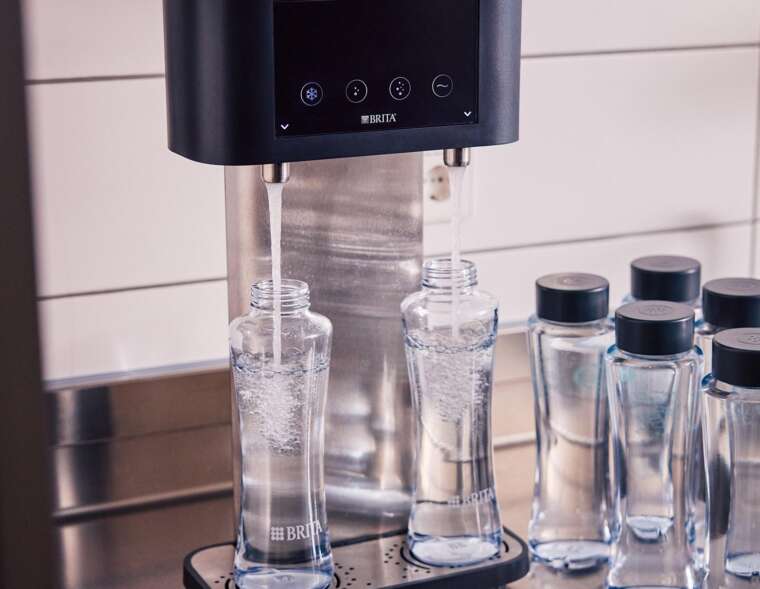 BRITA Fill T-Tap dispenser TwinFilling two reusable glass bottles simultaneously during peak service